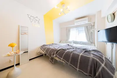 a small bedroom with a bed and a window at Felizstay Tokyo in Tokyo