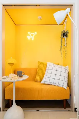a yellow living room with a couch and a table at Felizstay Tokyo in Tokyo