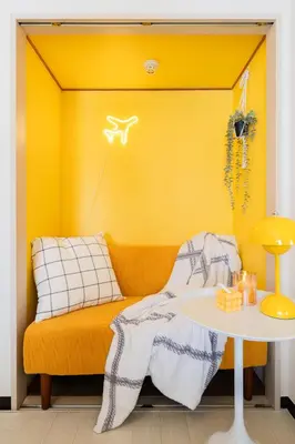a yellow couch in a room with a table at Felizstay Tokyo in Tokyo