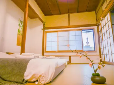 a bedroom with two beds and a window at 9Stay\u897f\u6d45\u8349 in Tokyo