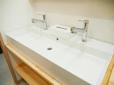 a bathroom with a white sink and two faucets at 9Stay\u897f\u6d45\u8349 in Tokyo