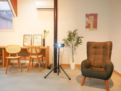 a living room with a chair and a table at 9Stay\u897f\u6d45\u8349 in Tokyo