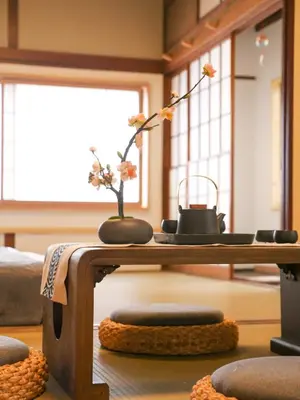 a table with two vases with flowers on it at 9Stay\u897f\u6d45\u8349 in Tokyo