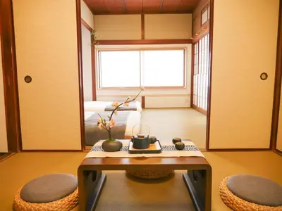 a living room with a table and two chairs at 9Stay\u897f\u6d45\u8349 in Tokyo