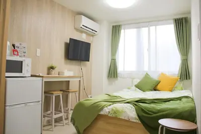 a small bedroom with a bed and a window at Sensoji 2ppl Apt in Tokyo