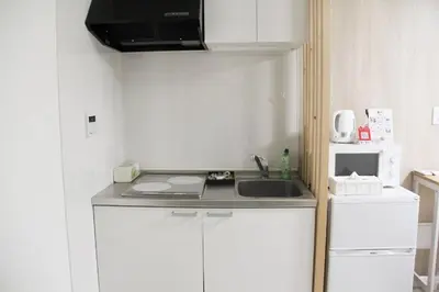 a small kitchen with a sink and a microwave at Sensoji 2ppl Apt in Tokyo