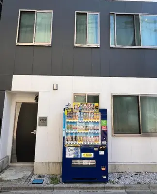 a drink vending machine in front of a building at Sensoji 2ppl Apt in Tokyo