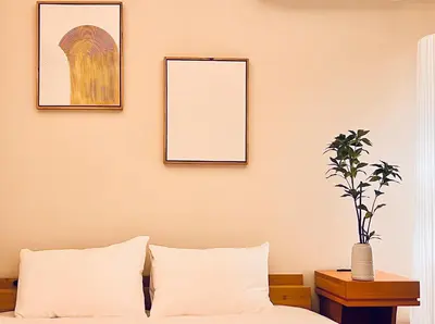 a bedroom with two framed pictures and a bed at \u65b0\u4e0a\u53cc\u5367\u5957\u623f \u6700\u59275\u4eba \u8bbe\u8ba1\u5e08\u98ce\u683cYaof \u4e1c\u4eac\u4e2d\u5fc3\u4e0a\u91ce\u516c\u56ed3\u5206\u949f \u8f66\u7ad91\u5206\u949f \u4f4d\u7f6e\u6781\u4f73\u8d85\u7ea7\u7e41\u534e \u623f\u95f4\u5185\u770b\u6a31\u82b1 in Tokyo