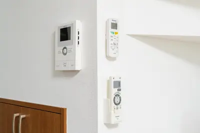two white controllers on the wall of a kitchen at Kashikirikotate - Vacation STAY 18912 in Tokyo