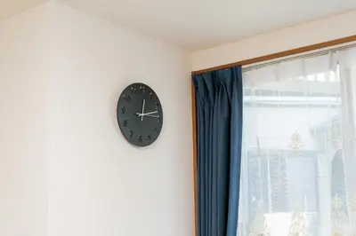 a clock on a wall next to a window at Kashikirikotate - Vacation STAY 18912 in Tokyo