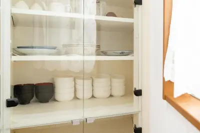 a cupboard filled with bowls and other dishes at Kashikirikotate - Vacation STAY 18912 in Tokyo