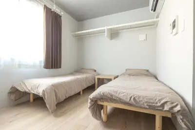 two beds in a bedroom with white walls and a window at Marvelous Higashikanda - Vacation STAY 85125v in Tokyo
