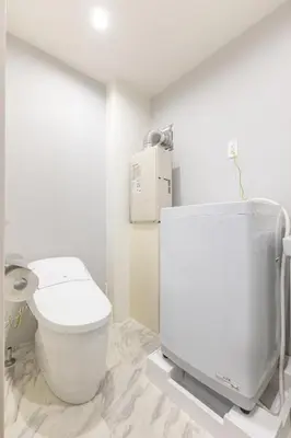 a white bathroom with a toilet and a tv at Marvelous Higashikanda - Vacation STAY 85125v in Tokyo