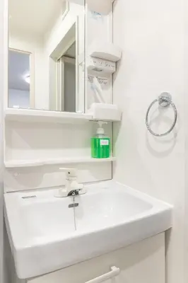 a white bathroom with a sink and a mirror at Marvelous Higashikanda - Vacation STAY 85125v in Tokyo