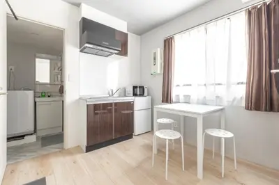 a kitchen with a counter and stools in a room at Marvelous Higashikanda - Vacation STAY 88274v in Tokyo