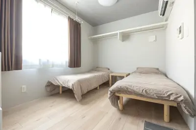 a bedroom with two beds and a window at Marvelous Higashikanda - Vacation STAY 88199v in Tokyo