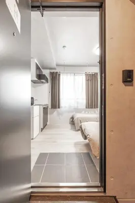 a bedroom with two beds and a mirror at Marvelous Higashikanda - Vacation STAY 88199v in Tokyo
