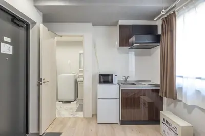 a small kitchen with a sink and a refrigerator at Marvelous Higashikanda - Vacation STAY 88199v in Tokyo