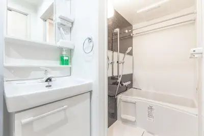 a white bathroom with a sink and a shower at Marvelous Higashikanda - Vacation STAY 88199v in Tokyo