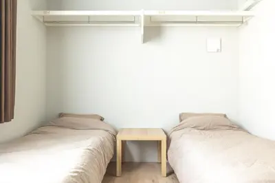 two beds in a room with a table between them at Marvelous Higashikanda - Vacation STAY 86902v in Tokyo
