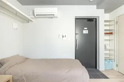 a bedroom with a bed next to a door at Marvelous Higashikanda - Vacation STAY 86902v in Tokyo