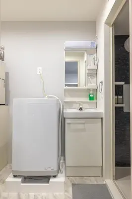 a white kitchen with a sink and a mirror at Marvelous Higashikanda - Vacation STAY 86902v in Tokyo