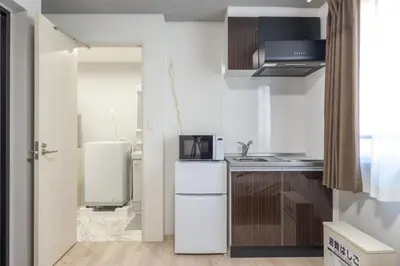 a small kitchen with a sink and a refrigerator at Marvelous Higashikanda - Vacation STAY 86893v in Tokyo