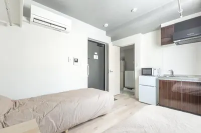 a white room with a bed and a kitchen at Marvelous Higashikanda - Vacation STAY 88263v in Tokyo