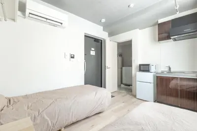 a bedroom with a bed and a kitchen at Marvelous Higashikanda - Vacation STAY 88263v in Tokyo