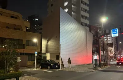 a man standing in front of a building at night at Hotel Alphinaud - Vacation STAY 91089v in Tokyo
