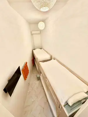 a small room with two beds and a chandelier at Hotel Alphinaud - Vacation STAY 91089v in Tokyo