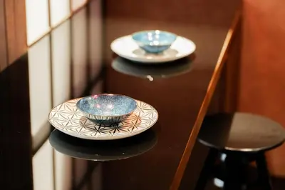 two plates and bowls sitting on a table at Solvana Akasaka in Tokyo