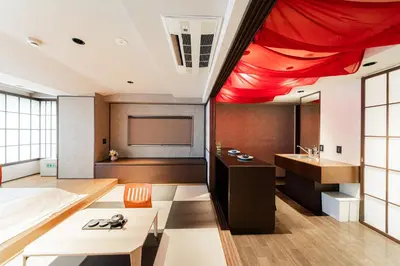 a room with a bed and a projection screen at Solvana Akasaka in Tokyo