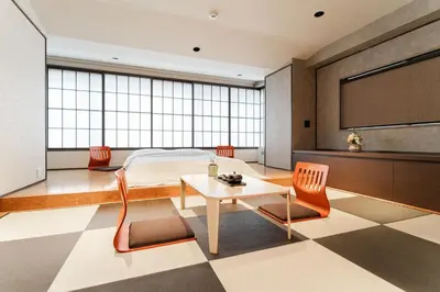a bedroom with a bed and a table and chairs at Solvana Akasaka in Tokyo