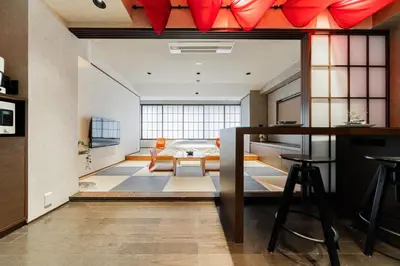 a large living room with a bed and a table at Solvana Akasaka in Tokyo