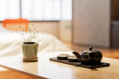 a tea kettle on a table with a potted plant at Solvana Akasaka in Tokyo