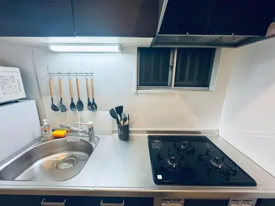 a kitchen counter with a sink and a stove at STS-Toyama house-SJ0188 in Tokyo