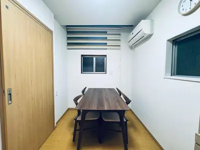 a wooden table in a room with a clock on the wall at STS-Toyama house-SJ0188 in Tokyo