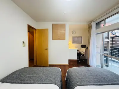 a bedroom with two beds and a window at STS-Toyama house-SJ0188 in Tokyo
