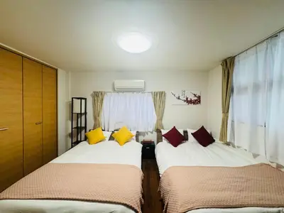 two beds in a small room with a window at STS-Toyama house-SJ0188 in Tokyo
