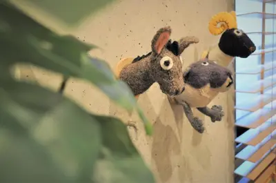 two stuffed animals on the side of a wall at \u539f\u7530\u5c4bHotel 3F in Tokyo
