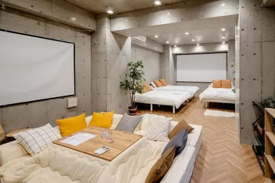 a living room with two beds and a couch at \u539f\u7530\u5c4bHotel 3F in Tokyo