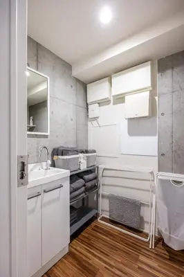 a white bathroom with a sink and a mirror at \u539f\u7530\u5c4bHotel 4F in Tokyo