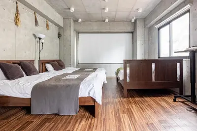 a bedroom with a large bed and a large window at \u539f\u7530\u5c4bHotel 4F in Tokyo