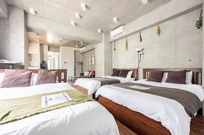 a group of three beds in a room at \u539f\u7530\u5c4bHotel 4F in Tokyo