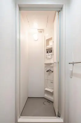a small white closet with a door open at Fullhouse 101 in Tokyo
