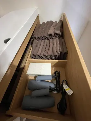 a wooden drawer filled with shirts and towels at Fullhouse 102 in Tokyo
