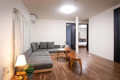 a living room with a couch and a table at Fullhouse 102 in Tokyo