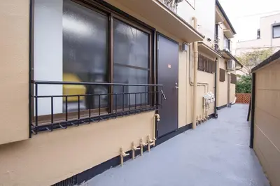 a balcony with windows on a building with snow on the ground at Fullhouse 102 in Tokyo