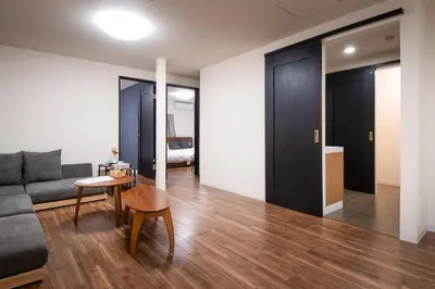 a living room with a couch and a table at Fullhouse 102 in Tokyo